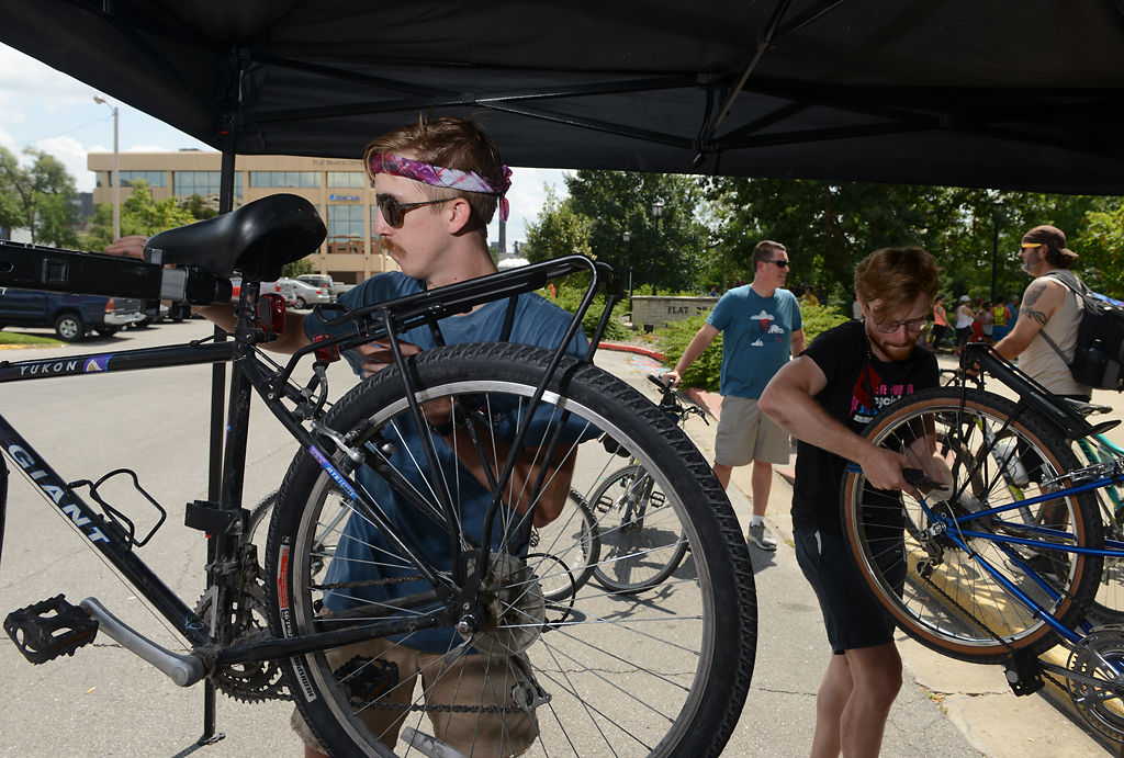 Cooper Mittelhauser, left, and Tyler Cordia, from Walt's Bike Shop, provide free bike checks